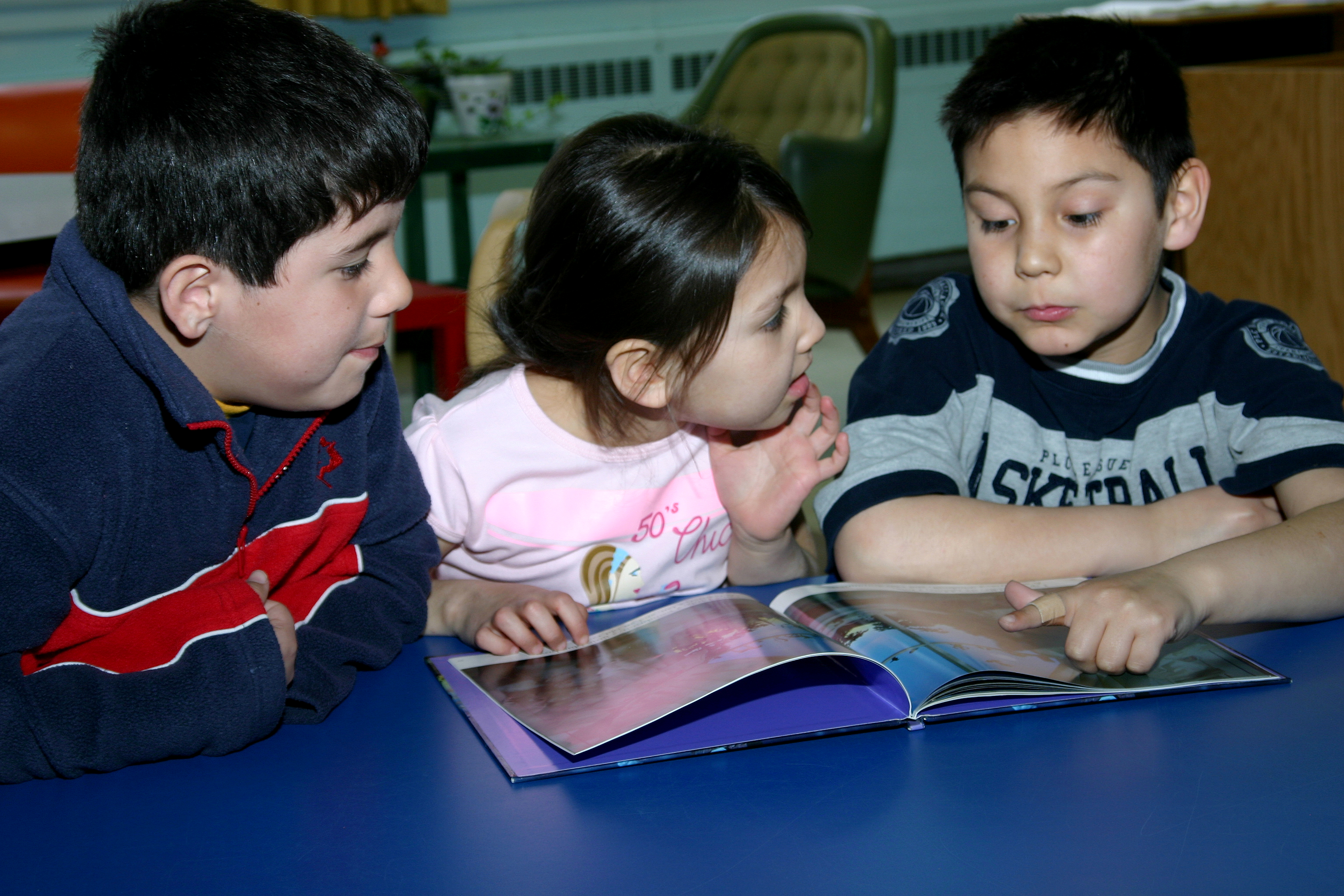 Miqmac students reading a book together